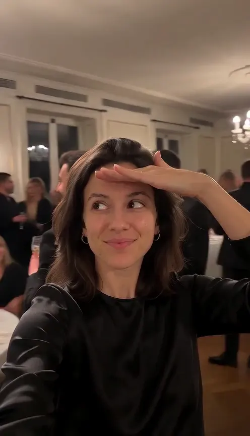 Burning Bridges AI video made from a solo selfie: a woman raises a glass, waves and shades her eyes